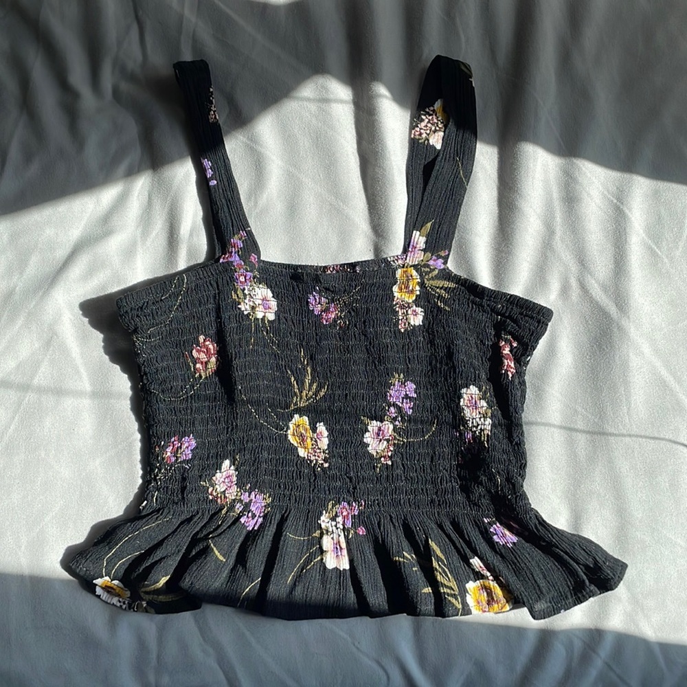 Strap, black floral top. Stretchy material, cropped